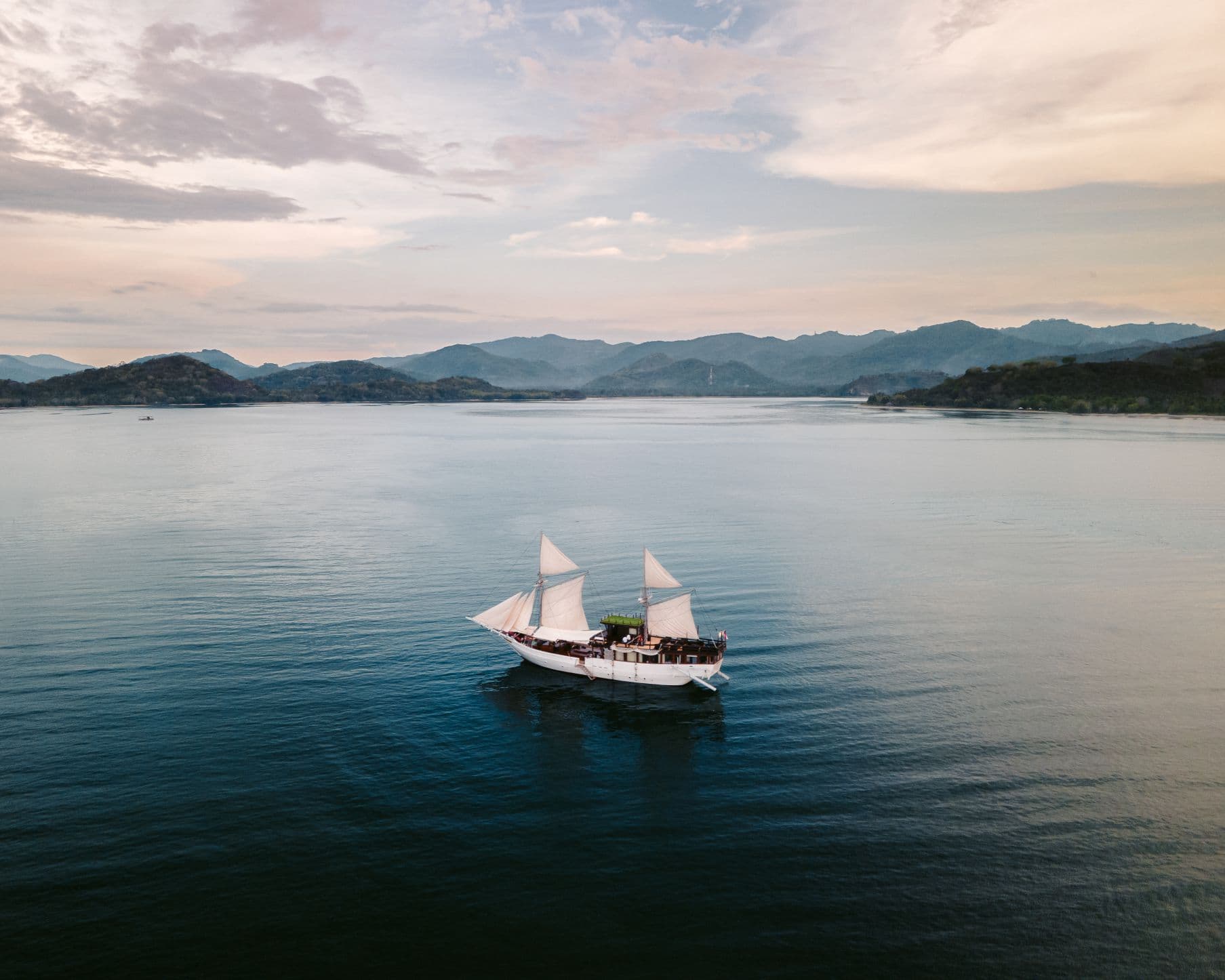 Ikan Kayu Yacht Aerial Golden Hour Sails Up